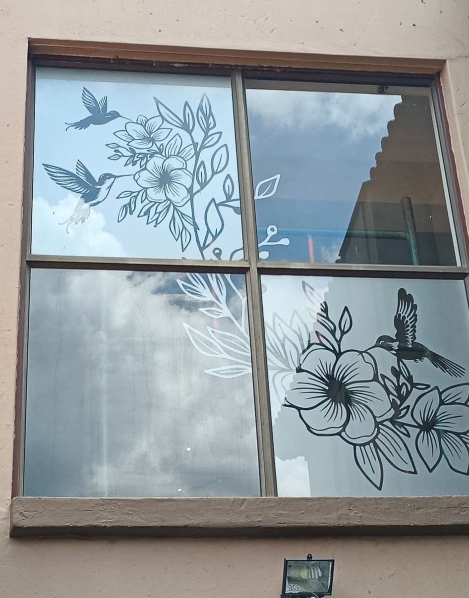 Decorative window film with hummingbird and floral design